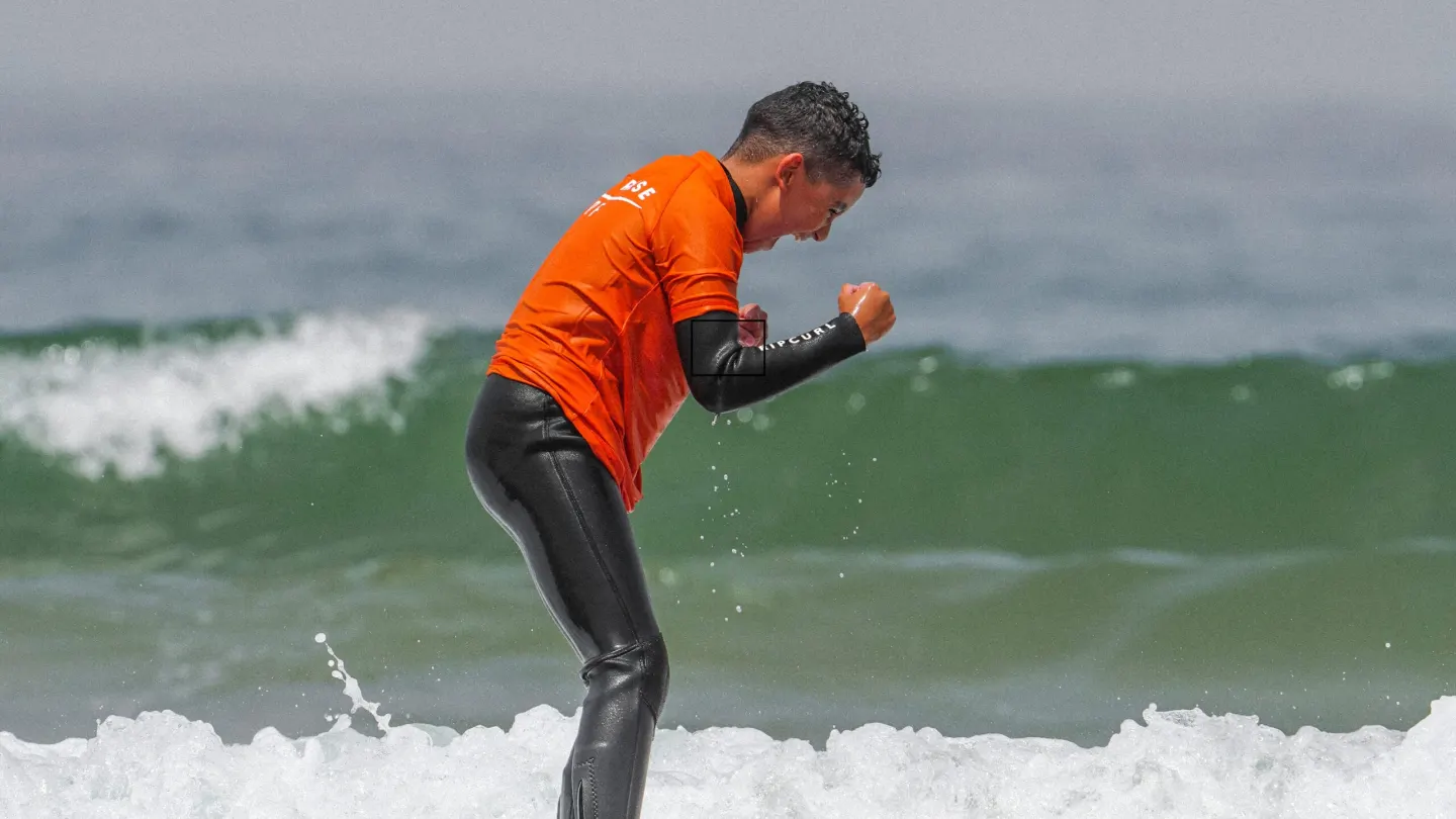 A surfer riding the whitewater towards the beach in Agadir